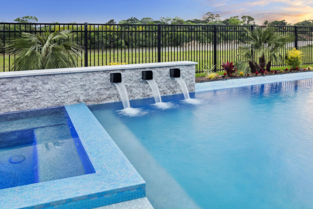 Custom pool with raised spa and sheer descent water features, Webster TX