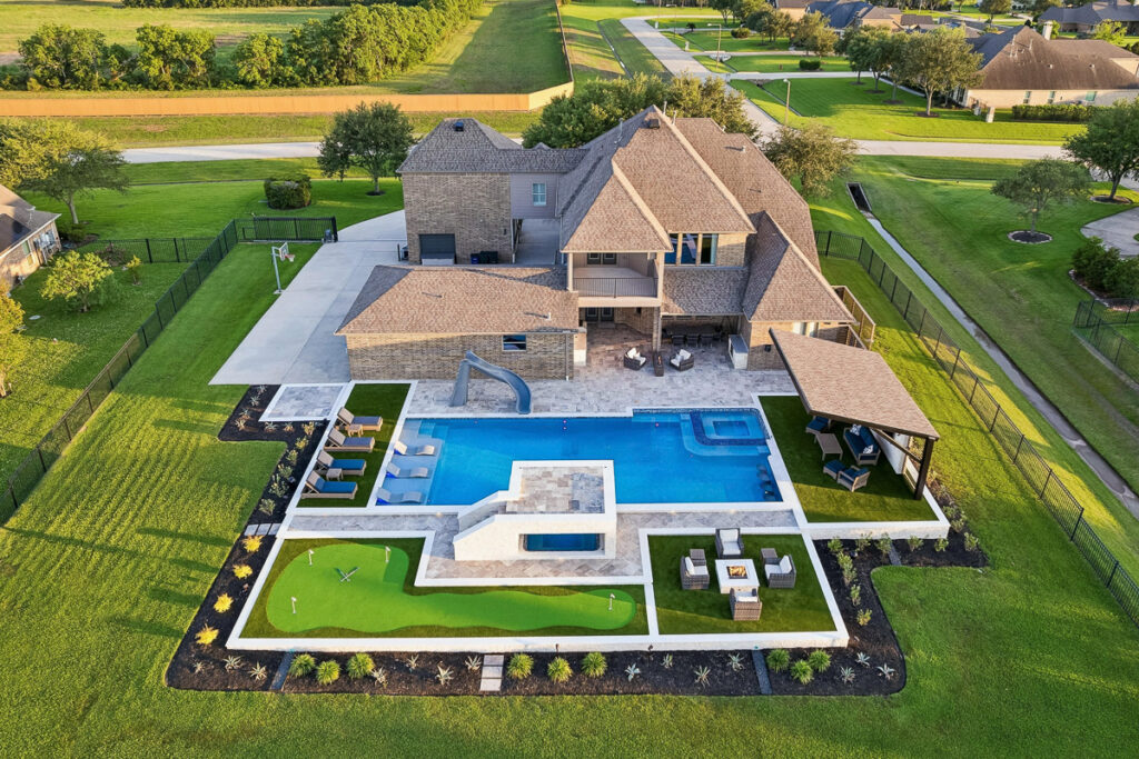 Aerial view of a custom pool and backyard by Pool Envy Designs